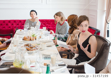 Women sitting at served table 31457199