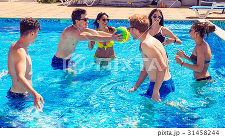 Group of cheerful couples friends playing water Group of cheerful couples friends playing water 31458244