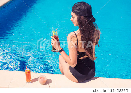 young sexy girl at swimming pool Drinking cocktail 31458285