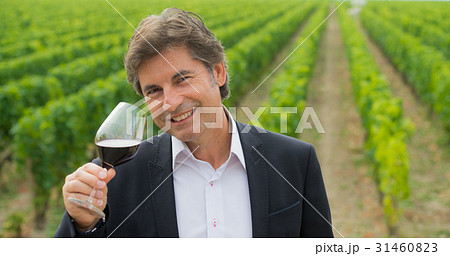 Portrait confidant vintner drinking red wine in winery 31460823