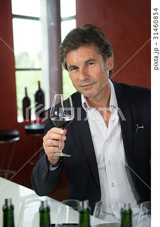 Portrait confidant vintner drinking red wine in winery 31460854