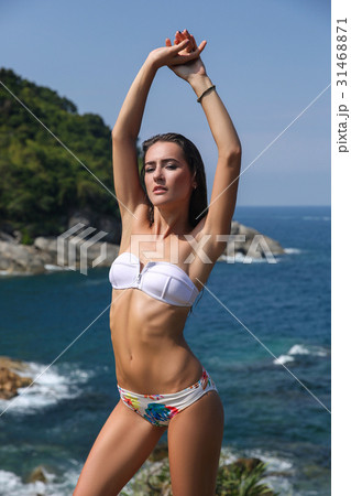 Bikini model girl posing sexy at tropical beach  31468871