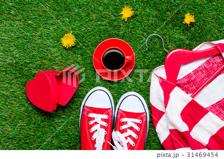 gumshoes, jacket on hanger, cup of coffee and box gumshoes, jacket on hanger, cup of coffee and box 31469454