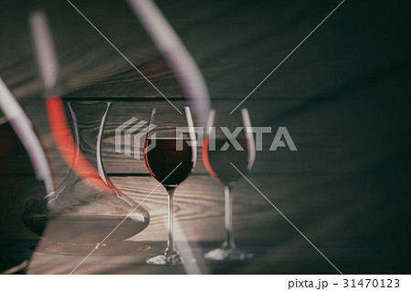 Two glasses and decanter of red wine on a dark 31470123
