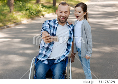 Positive father and daughter looking straight at 31478329