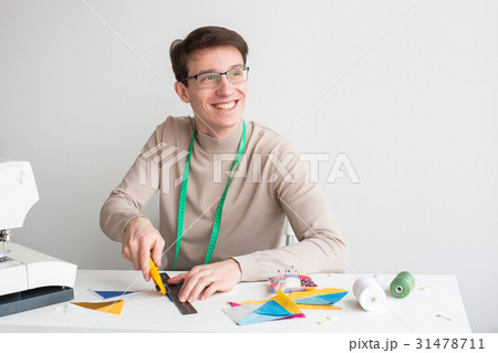 quilting - smiling young male tailor sitting 31478711