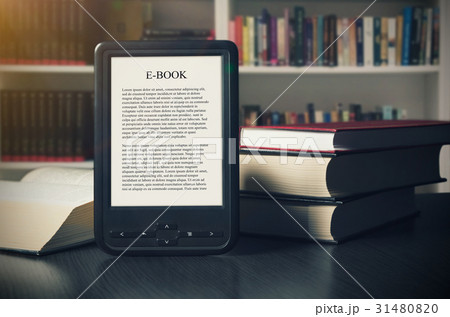 E-book reader device on desk in library 31480820