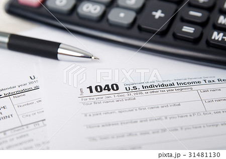 US tax form 1040 with pen and calculator US tax form 1040 with pen and calculator 31481130