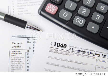 US tax form 1040 with pen and calculator US tax form 1040 with pen and calculator 31481131