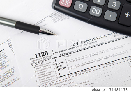 US tax form 1120 with pen and calculator 31481133