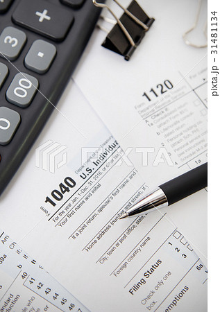 US tax form 1040 with pen and calculator 31481134
