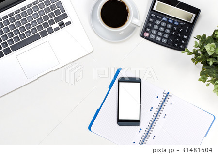 Office desk with laptop, and supplies top view 31481604