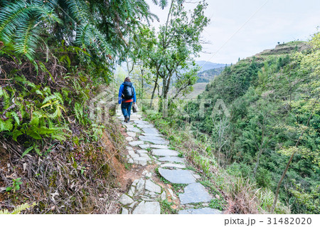 tourist on path on mountain slope in Dazhai tourist on path on mountain slope in Dazhai 31482020