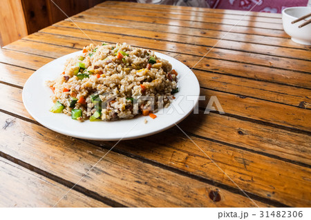 served fried rice with vegetables on plate 31482306