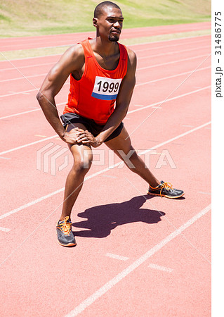 Athlete warming up on the running track Athlete warming up on the running track 31486775