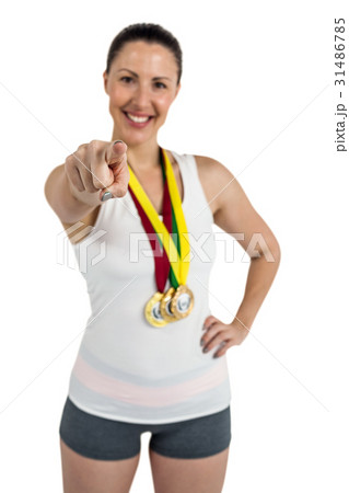Female athlete posing with gold medals around his neck 31486785