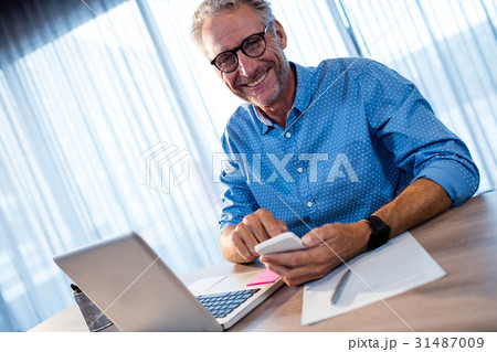 Businessman using a smartphone Businessman using a smartphone 31487009