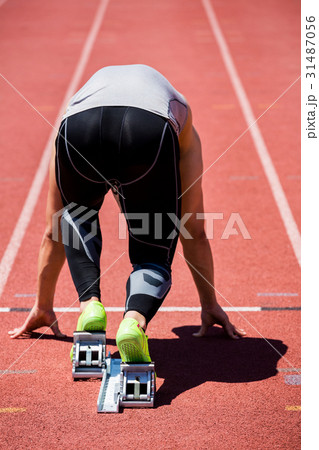 Athlete on a starting block about to run 31487056
