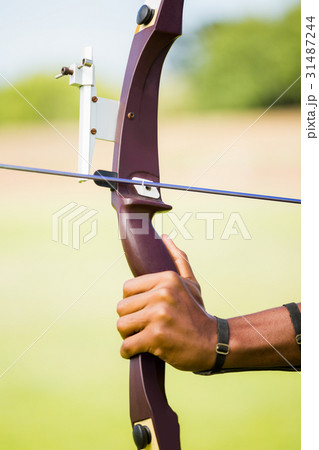 Athlete practicing archery 31487244