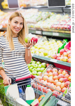 Customer at supermarket front of fruits shelf Customer at supermarket front of fruits shelf 31487309