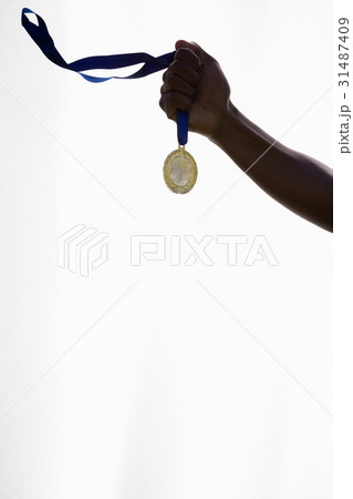 Hand of athlete holding gold medal 31487409