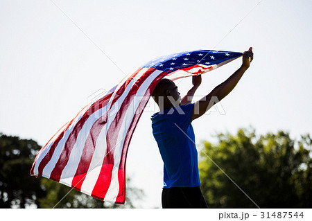 Athlete holding an american flag 31487544