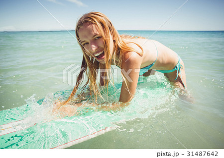 Woman surfing in sea Woman surfing in sea 31487642
