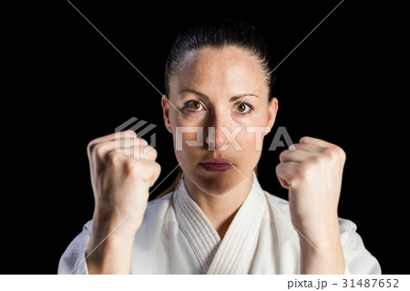 Female fighter performing karate stance 31487652