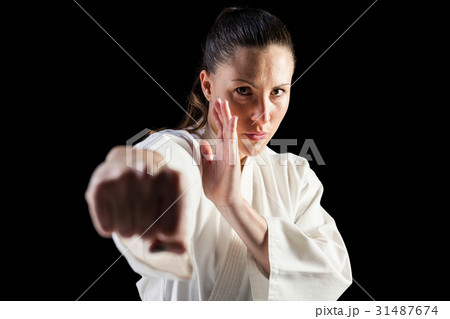 Female fighter performing karate stance 31487674