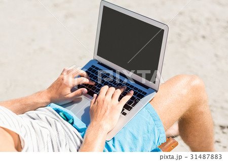 Man sitting on armchair at beach 31487883