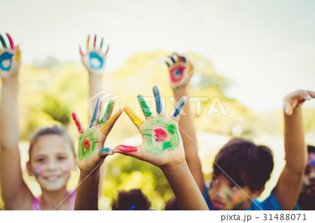 Portrait of cute children with make up having coloured hands Portrait of cute children with make up having coloured hands 31488071