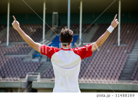 Excited football player standing in stadium 31488169