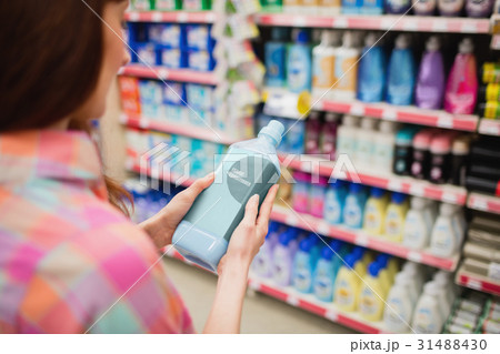 Rear view of woman holding detergent Rear view of woman holding detergent 31488430