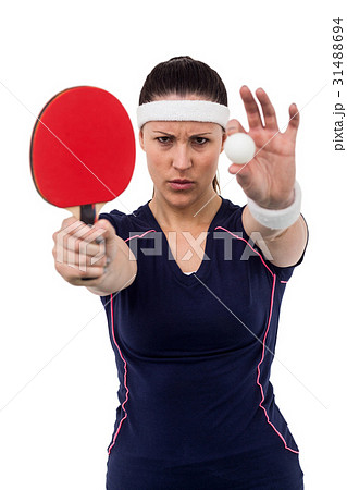 Female athlete holding table tennis paddle and ball 31488694