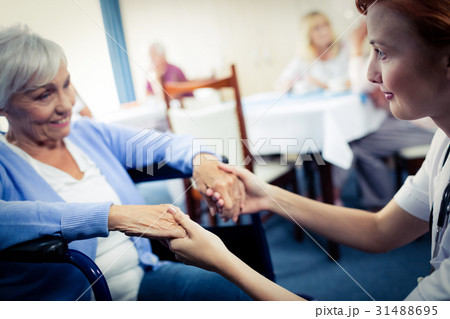 Nurse taking care of a senior woman 31488695
