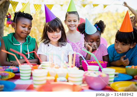 Cute children looking candles during a birthday party Cute children looking candles during a birthday party 31488942