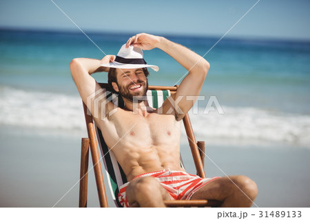 Young man relaxing on armchair 31489133