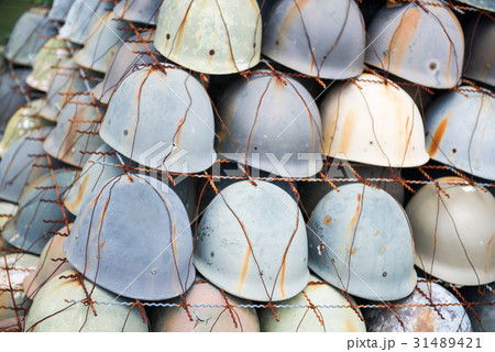 old green soldier helmet in front od barracks 31489421