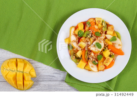 pear, kiwi, apricot,mango salad with muesli pear, kiwi, apricot,mango salad with muesli 31492449