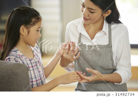Mother and daughter are playing, holding hands and talking together. 31492734