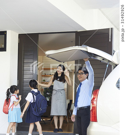 An Asian family is saying goodbye to go to school at door. An Asian family is saying goodbye to go to school at door. 31492926