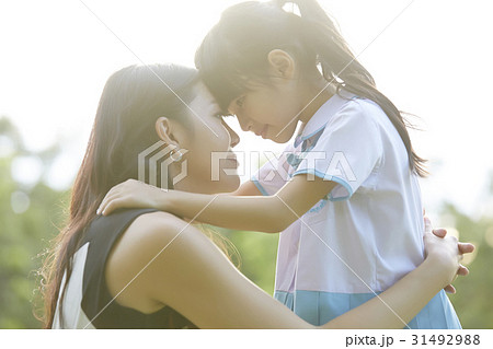mother is hugging and forehead touching her daughter 31492988