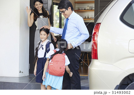 dad is touching his daughters' head when mom is waving dad is touching his daughters' head when mom is waving 31493002