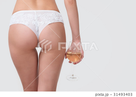 Slim, beautiful woman in lace lingerie with glass 31493403