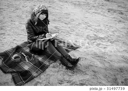 girl sitting on the beach  31497739