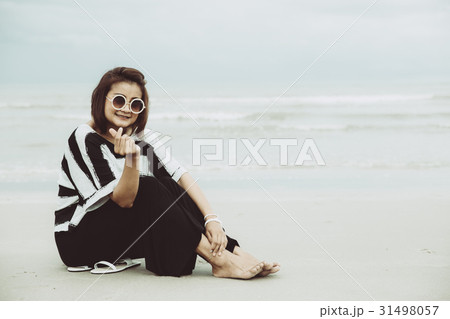 portrait asian single hipster indy on the beach 31498057