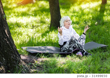 Concentrated senior lady having relaxation time in 31499650