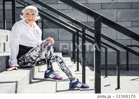 Joyful aged lady relaxing after climbing upstairs 31500170