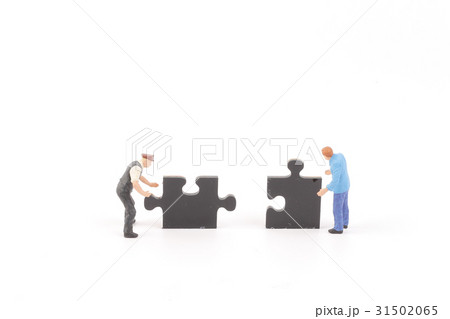 figure holding up jigsaw puzzle pieces 31502065