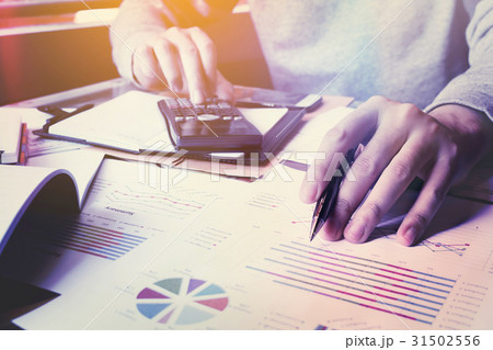 Businessman thinking about cost and doing finance Businessman thinking about cost and doing finance 31502556